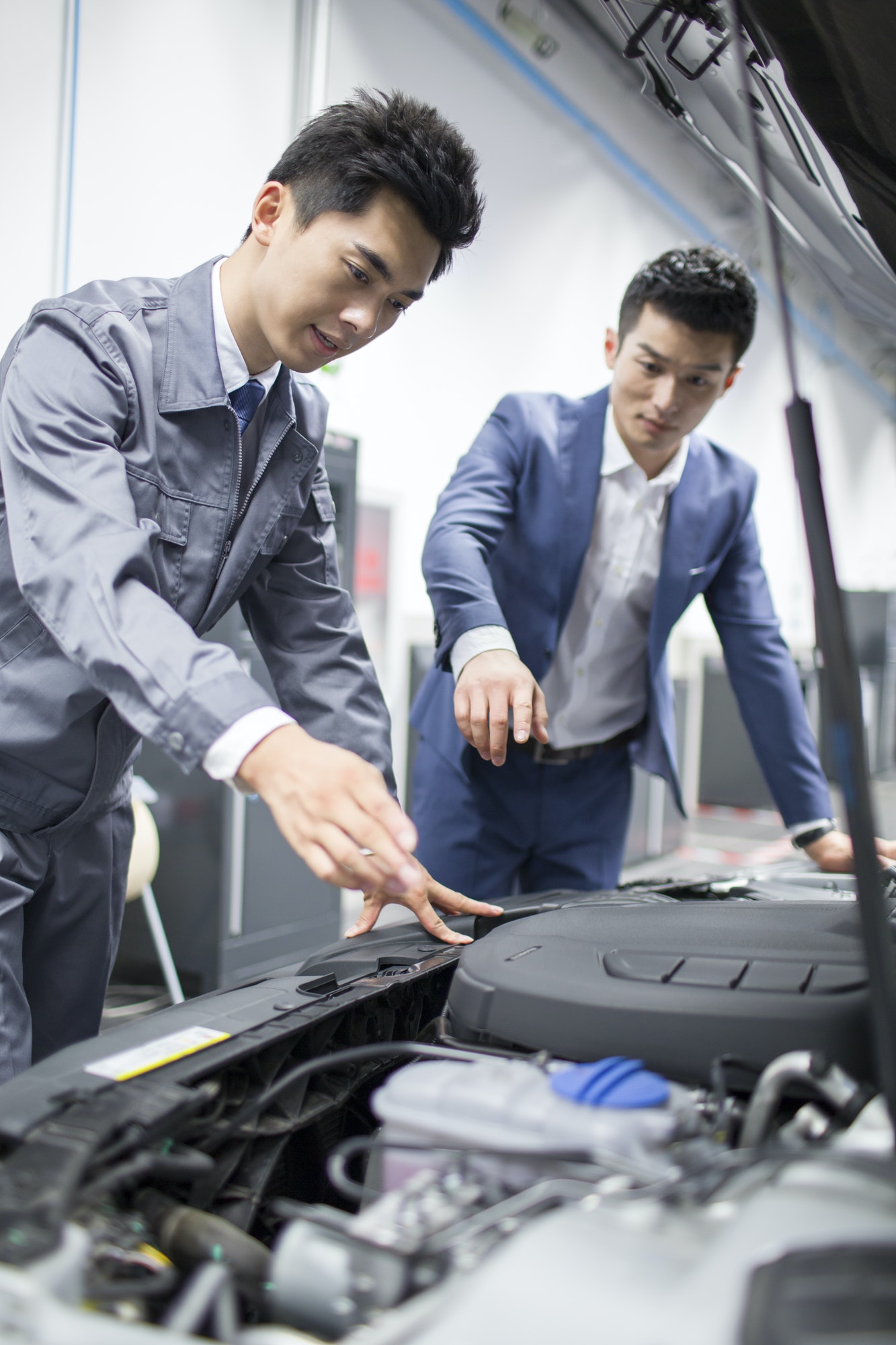 Auto mechanic talking with car owner